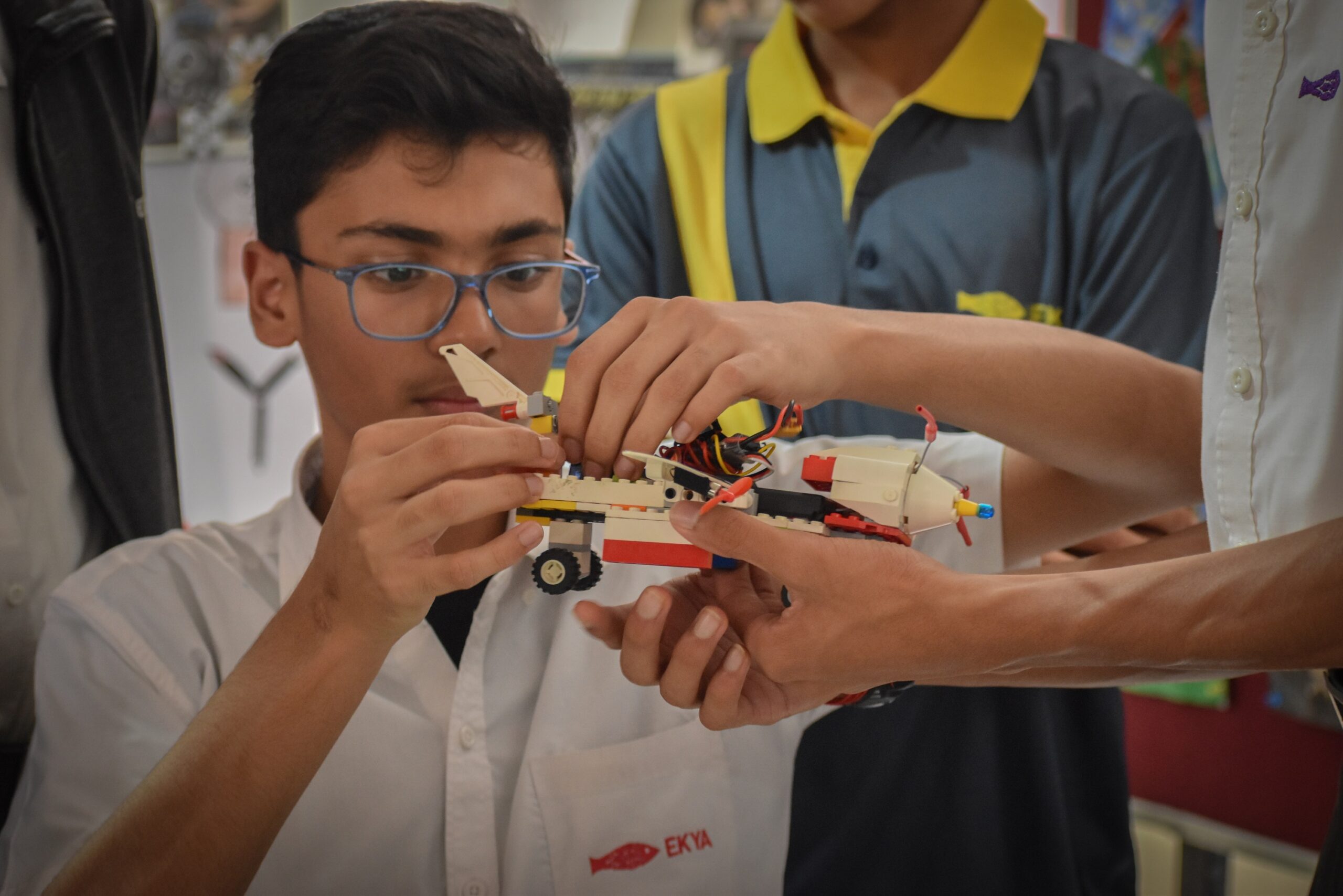 Student at Ekya Nava, an international school in Bangalore, engaged in purpose-based learning by making a model vehicle, demonstrating hands-on skills.