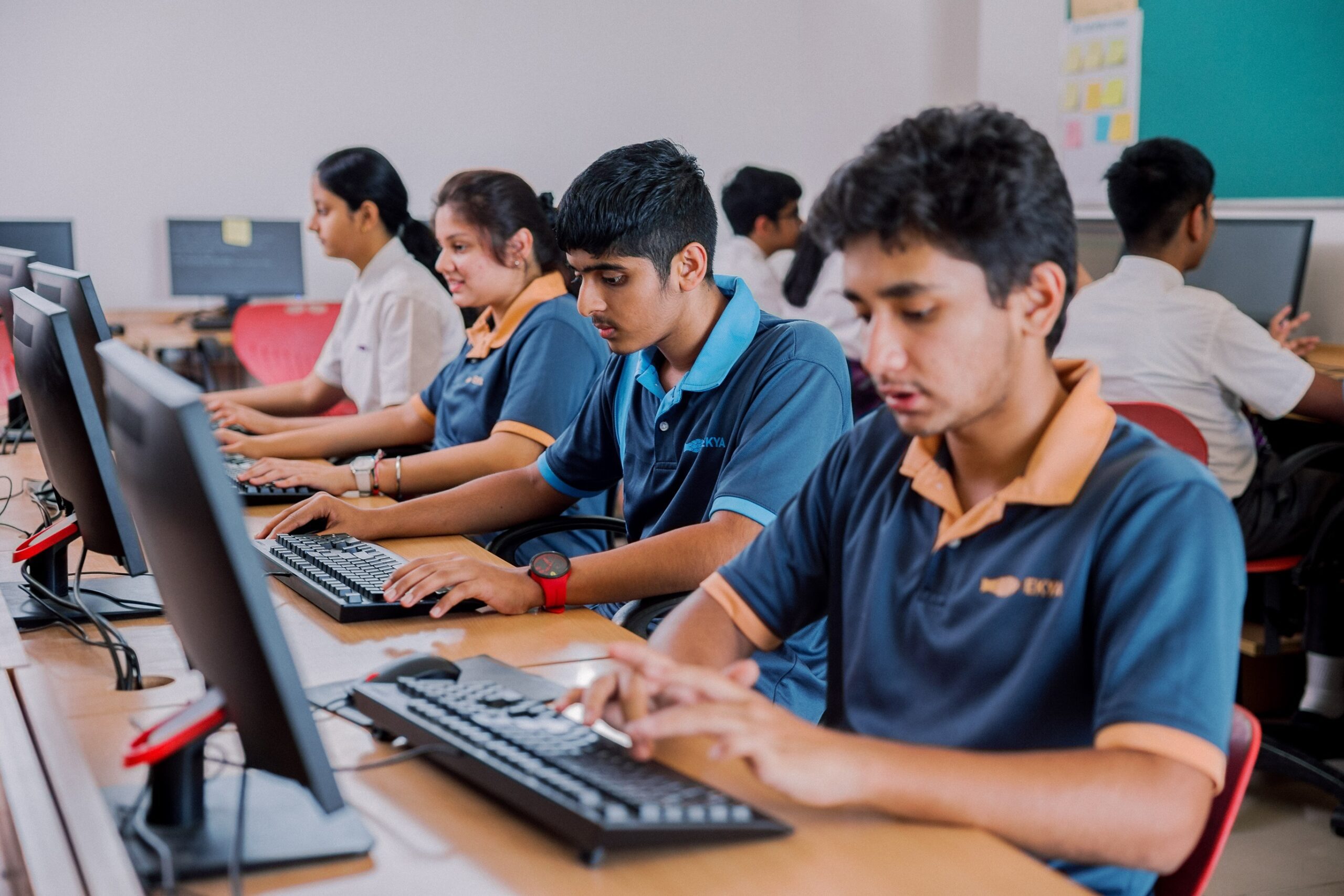 Ekya Nava IGCSE students in Bangalore engage in purpose-based learning through Information Technology & Society, using computers in a modern classroom setting.